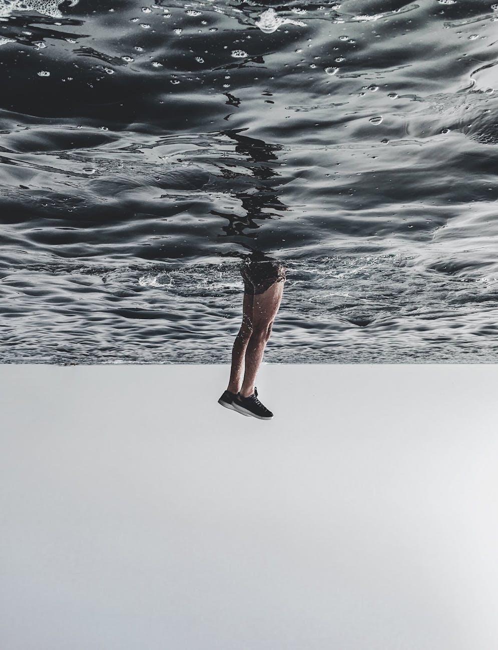 person diving on body of water